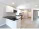 Open concept kitchen and dining area with granite countertop, white cabinets, and stainless appliances at 426 Williamson St, Rock Hill, SC 29730