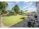 Expansive backyard with patio seating, a well-manicured lawn, and mature trees at 4732 Meadowfield Rd # L35, Charlotte, NC 28215