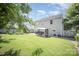 Backyard with patio, lush green lawn, mature trees, and a two-story house at 4732 Meadowfield Rd # L35, Charlotte, NC 28215