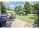 Green backyard featuring a patio with outdoor seating and a built-in grill at 4732 Meadowfield Rd # L35, Charlotte, NC 28215