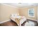 Cozy bedroom with dark wood floors and natural light at 4732 Meadowfield Rd # L35, Charlotte, NC 28215