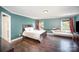 Relaxing bedroom with hardwood floors, a hammock, and abundant natural light at 4732 Meadowfield Rd # L35, Charlotte, NC 28215
