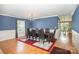 Formal dining room with chair rail molding, stylish chandelier and hardwood floors at 4732 Meadowfield Rd # L35, Charlotte, NC 28215