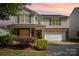Charming two-story home featuring green shutters, brick accents, and a well-manicured front yard at 4732 Meadowfield Rd # L35, Charlotte, NC 28215