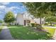 Well-maintained home with a green lawn, mature tree, sidewalk and a cozy front porch at 4732 Meadowfield Rd # L35, Charlotte, NC 28215