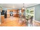 Bright kitchen features wood cabinets, stainless steel appliances, and an adjacent dining area with sliding glass doors at 4732 Meadowfield Rd # L35, Charlotte, NC 28215
