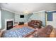 Inviting living room features a cozy fireplace, chandelier, and a comfortable leather sofa at 4732 Meadowfield Rd # L35, Charlotte, NC 28215
