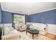 Cozy living room with chair rail molding, stylish chandelier, hardwood floors and bright natural light at 4732 Meadowfield Rd # L35, Charlotte, NC 28215