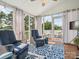 Relaxing back porch with comfortable seating, ceiling fan, and views of the lush landscape at 500 Landau Rd, Waxhaw, NC 28173
