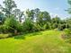 Well-maintained lawn with mature trees offering shade and privacy in the backyard at 500 Landau Rd, Waxhaw, NC 28173