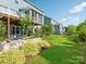 Beautifully landscaped backyard features a screened porch, stone patio, and lush lawn at 500 Landau Rd, Waxhaw, NC 28173