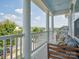 Inviting balcony featuring white columns, comfortable bench seating, and scenic neighborhood views at 500 Landau Rd, Waxhaw, NC 28173