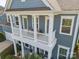 Front balcony featuring columns, seating, and views of the surrounding area at 500 Landau Rd, Waxhaw, NC 28173