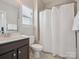 Clean bathroom features a white shower curtain, dark vanity, and white sink at 500 Landau Rd, Waxhaw, NC 28173