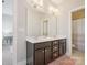 Bathroom includes double sinks, dark cabinets, large mirror, and neutral walls at 500 Landau Rd, Waxhaw, NC 28173