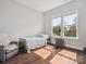 Sunlit bedroom with hardwood floors, a comfortable bed, and a view of the outdoors at 500 Landau Rd, Waxhaw, NC 28173