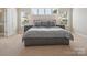 Calm bedroom showcases a comfy bed framed by two bedside tables and bright windows at 500 Landau Rd, Waxhaw, NC 28173
