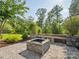 Inviting outdoor fire pit area with stone seating, perfect for entertaining guests at 500 Landau Rd, Waxhaw, NC 28173