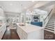Open kitchen with a large island, white cabinetry, and views of the living and dining areas at 500 Landau Rd, Waxhaw, NC 28173