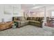Spacious living room featuring a cozy L-shaped sofa and view of the kitchen at 500 Landau Rd, Waxhaw, NC 28173