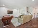 Bright recreation room with a foosball table, media center, and direct access to the stairs at 500 Landau Rd, Waxhaw, NC 28173