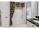 Bright bathroom featuring a tub with a decorative curtain and a vanity with a dark countertop at 5572 Yorke Nw St, Concord, NC 28027