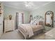 Cozy bedroom featuring a decorative bed frame, neutral colors, and natural light at 5572 Yorke Nw St, Concord, NC 28027