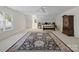 Spacious bedroom with neutral walls, large rug, and a cozy seating area at 5572 Yorke Nw St, Concord, NC 28027