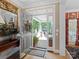 Warm entryway showcasing hardwood floors, elegant decor, and a glimpse of the inviting front porch at 5572 Yorke Nw St, Concord, NC 28027
