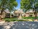 Suburban home boasts lush landscaping and a charming porch, nestled in a quiet neighborhood at 5572 Yorke Nw St, Concord, NC 28027