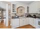 Well-lit kitchen features granite countertops, white cabinetry, stainless steel appliances, and hardwood flooring at 5572 Yorke Nw St, Concord, NC 28027