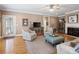 Spacious living room with hardwood flooring, a fireplace, built-in cabinets, and neutral-toned walls at 5572 Yorke Nw St, Concord, NC 28027