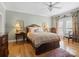 Comfortable bedroom with hardwood flooring, a ceiling fan, natural lighting, and neutral paint at 5572 Yorke Nw St, Concord, NC 28027