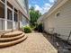 Brick patio area with stairs leading to porches on two sides of the house at 5572 Yorke Nw St, Concord, NC 28027