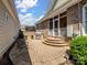 Brick patio features an outdoor grill and steps that lead to a screened-in porch at 5572 Yorke Nw St, Concord, NC 28027