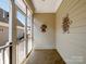 Enclosed porch with neutral siding, decorative wall art, and a screen door leading to the outside at 5572 Yorke Nw St, Concord, NC 28027