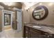 Bathroom showcasing a vanity with granite countertop and a round mirror at 6800 Augustine Way, Charlotte, NC 28270