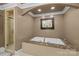 Luxurious bathroom with marble-trimmed tub, glass-enclosed shower, and recessed lighting at 6800 Augustine Way, Charlotte, NC 28270