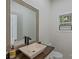 Bathroom features a modern vanity with a sink, a mirror, and a window at 6800 Augustine Way, Charlotte, NC 28270
