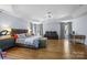 Large bedroom features a tray ceiling, hardwood floors, sitting area, and many windows at 6800 Augustine Way, Charlotte, NC 28270