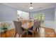 Dining room features a dining table set for eight, hardwood floors and abundant natural light at 6800 Augustine Way, Charlotte, NC 28270