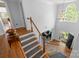 Grand foyer features hardwood floors, a staircase with white railings, and a view of the office at 6800 Augustine Way, Charlotte, NC 28270