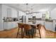Modern kitchen with stainless steel appliances, a large island with seating, and hardwood floors at 6800 Augustine Way, Charlotte, NC 28270