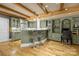 This inviting kitchen features rustic wood beams and a granite countertop bar for casual dining at 6800 Augustine Way, Charlotte, NC 28270