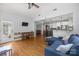 Open concept living room with a door to the outside, a view of the kitchen and hardwood floors at 6800 Augustine Way, Charlotte, NC 28270