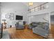 Living room featuring large furniture, hardwood floors, and a view of the upper level at 6800 Augustine Way, Charlotte, NC 28270