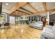 Open living room with exposed beams, built in bar and shelving, and seating area at 6800 Augustine Way, Charlotte, NC 28270