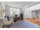 Sunlit home office with large windows, neutral carpet, modern desk and chair with adjacent entry foyer at 6800 Augustine Way, Charlotte, NC 28270