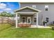 Backyard featuring a covered patio, grill, and well-manicured lawn with a wood fence at 7025 Amberhouse Dr, Charlotte, NC 28212