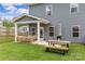 Spacious backyard with a covered patio and wooden picnic table at 7025 Amberhouse Dr, Charlotte, NC 28212